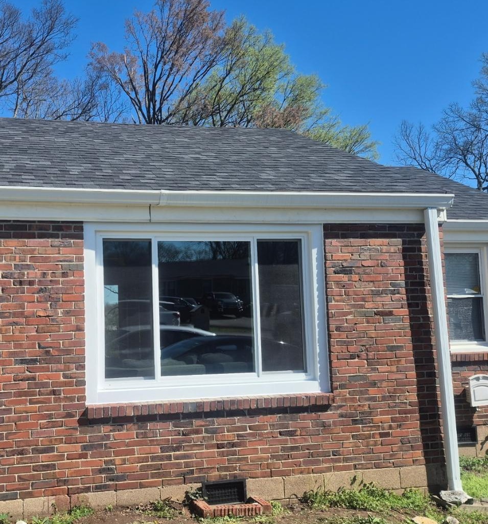 Finished picture window installation on a brick home